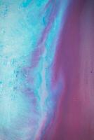 Abstract created using the technique of liquid acrylic. Macro photography of the smallest details of a panting. The panting shows how overflows of shades and colors of paint resemble space motifs. photo