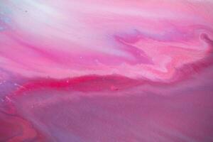 Abstract created using the technique of liquid acrylic. Macro photography of the smallest details of a panting. The panting shows how overflows of shades and colors of paint resemble space motifs. photo