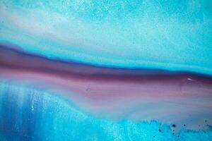 Abstract created using the technique of liquid acrylic. Macro photography of the smallest details of a panting. The panting shows how overflows of shades and colors of paint resemble space motifs. photo