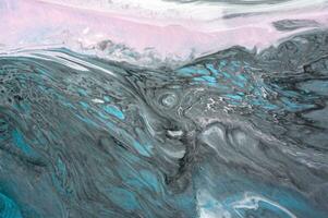 Abstract created using the technique of liquid acrylic. Macro photography of the smallest details of a picture. The picture shows how overflows of shades and colors of paint resemble space motifs. photo