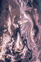 Abstract created using the technique of liquid acrylic. Macro photography of the smallest details of a picture. The picture shows how overflows of shades and colors of paint resemble space motifs. photo