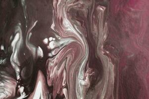 Abstract created using the technique of liquid acrylic. Macro photography of the smallest details of a picture. The picture shows how overflows of shades and colors of paint resemble space motifs. photo