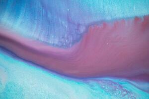 Abstract created using the technique of liquid acrylic. Macro photography of the smallest details of a panting. The panting shows how overflows of shades and colors of paint resemble space motifs. photo