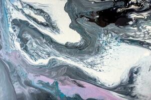 Abstract created using the technique of liquid acrylic. Macro photography of the smallest details of a picture. The picture shows how overflows of shades and colors of paint resemble space motifs. photo