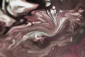Abstract created using the technique of liquid acrylic. Macro photography of the smallest details of a picture. The picture shows how overflows of shades and colors of paint resemble space motifs. photo