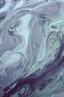 Abstract created using the technique of liquid acrylic. Macro photography of the smallest details of a panting. The panting shows how overflows of shades and colors of paint resemble space motifs. photo