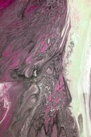 Abstract created using the technique of liquid acrylic. Macro photography of the smallest details of a picture. The picture shows how overflows of shades and colors of paint resemble space motifs. photo