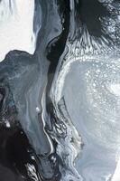 Abstract created using the technique of liquid acrylic. Macro photography of the smallest details of a picture. The picture shows how overflows of shades and colors of paint resemble space motifs. photo