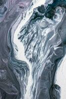 Abstract created using the technique of liquid acrylic. Macro photography of the smallest details of a picture. The picture shows how overflows of shades and colors of paint resemble space motifs. photo