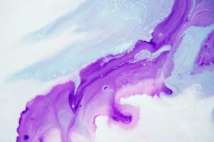 Abstract created using the technique of liquid acrylic. Macro photography of the smallest details of a panting. The panting shows how overflows of shades and colors of paint resemble space motifs. photo