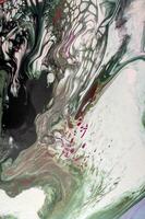Abstract created using the technique of liquid acrylic. Macro photography of the smallest details of a picture. The picture shows how overflows of shades and colors of paint resemble space motifs. photo