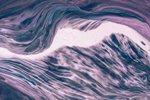 Abstract created using the technique of liquid acrylic. Macro photography of the smallest details of a picture. The picture shows how overflows of shades and colors of paint resemble space motifs. photo