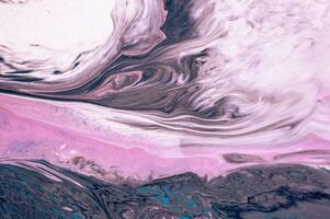 Abstract created using the technique of liquid acrylic. Macro photography of the smallest details of a picture. The picture shows how overflows of shades and colors of paint resemble space motifs. photo