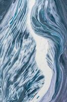 Abstract created using the technique of liquid acrylic. Macro photography of the smallest details of a picture. The picture shows how overflows of shades and colors of paint resemble space motifs. photo