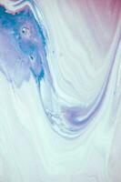 Abstract created using the technique of liquid acrylic. Macro photography of the smallest details of a panting. The panting shows how overflows of shades and colors of paint resemble space motifs. photo