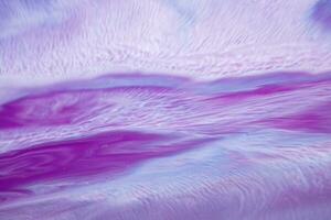 Abstract created using the technique of liquid acrylic. Macro photography of the smallest details of a picture. The picture shows how overflows of shades and colors of paint resemble space motifs. photo