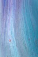 Abstract created using the technique of liquid acrylic. Macro photography of the smallest details of a picture. The picture shows how overflows of shades and colors of paint resemble space motifs. photo