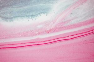 Abstract created using the technique of liquid acrylic. Macro photography of the smallest details of a picture. The picture shows how overflows of shades and colors of paint resemble space motifs. photo