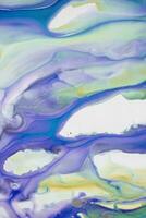 Abstract created using the technique of liquid acrylic. Macro photography of the smallest details of a picture. The picture shows how overflows of shades and colors of paint resemble space motifs. photo