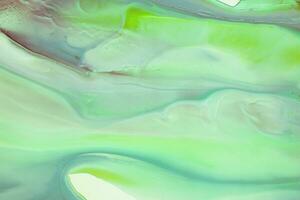 Abstract created using the technique of liquid acrylic. Macro photography of the smallest details of a picture. The picture shows how overflows of shades and colors of paint resemble space motifs. photo