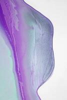 Abstract created using the technique of liquid acrylic. Macro photography of the smallest details of a picture. The picture shows how overflows of shades and colors of paint resemble space motifs. photo