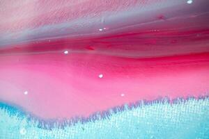 Abstract created using the technique of liquid acrylic. Macro photography of the smallest details of a panting. The panting shows how overflows of shades and colors of paint resemble space motifs. photo