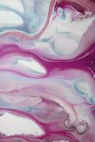 Abstract created using the technique of liquid acrylic. Macro photography of the smallest details of a picture. The picture shows how overflows of shades and colors of paint resemble space motifs. photo