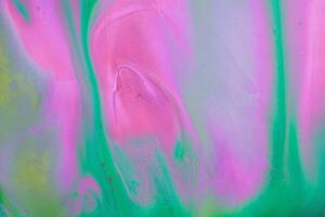 Abstract created using the technique of liquid acrylic. Macro photography of the smallest details of a picture. The picture shows how overflows of shades and colors of paint resemble space motifs. photo