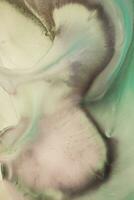 Abstract created using the technique of liquid acrylic. Macro photography of the smallest details of a picture. The picture shows how overflows of shades and colors of paint resemble space motifs. photo