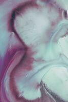 Abstract created using the technique of liquid acrylic. Macro photography of the smallest details of a picture. The picture shows how overflows of shades and colors of paint resemble space motifs. photo