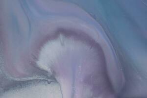 Abstract created using the technique of liquid acrylic. Macro photography of the smallest details of a picture. The picture shows how overflows of shades and colors of paint resemble space motifs. photo