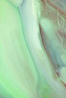 Abstract created using the technique of liquid acrylic. Macro photography of the smallest details of a picture. The picture shows how overflows of shades and colors of paint resemble space motifs. photo