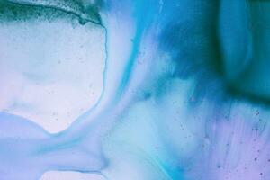 Abstract created using the technique of liquid acrylic. Macro photography of the smallest details of a picture. The picture shows how overflows of shades and colors of paint resemble space motifs. photo