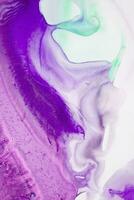 Abstract created using the technique of liquid acrylic. Macro photography of the smallest details of a picture. The picture shows how overflows of shades and colors of paint resemble space motifs. photo