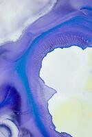 Abstract created using the technique of liquid acrylic. Macro photography of the smallest details of a picture. The picture shows how overflows of shades and colors of paint resemble space motifs. photo