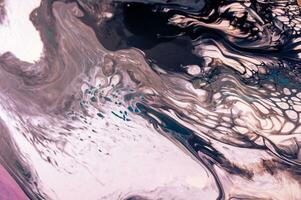 Abstract created using the technique of liquid acrylic. Macro photography of the smallest details of a picture. The picture shows how overflows of shades and colors of paint resemble space motifs. photo