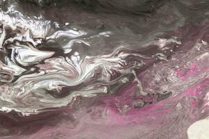 Abstract created using the technique of liquid acrylic. Macro photography of the smallest details of a picture. The picture shows how overflows of shades and colors of paint resemble space motifs. photo