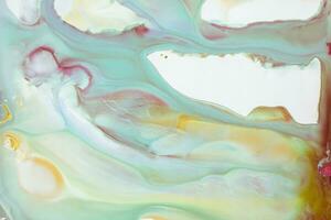 Abstract created using the technique of liquid acrylic. Macro photography of the smallest details of a picture. The picture shows how overflows of shades and colors of paint resemble space motifs. photo