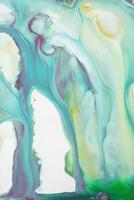 Abstract created using the technique of liquid acrylic. Macro photography of the smallest details of a picture. The picture shows how overflows of shades and colors of paint resemble space motifs. photo