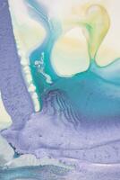Abstract created using the technique of liquid acrylic. Macro photography of the smallest details of a picture. The picture shows how overflows of shades and colors of paint resemble space motifs. photo