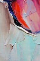 Multicolored texture painting. Abstract art background. oil on canvas. Rough brushstrokes of paint. Closeup of a painting by oil and palette knife. Highly-textured, high quality details. photo