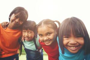 Close up of girl child friends in a park smiling to camera photo