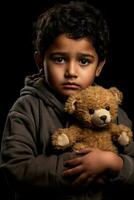 Grieving immigrant boy clutching worn teddy bear isolated on a gray gradient background photo