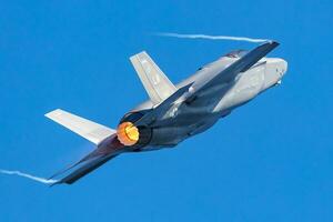 US Air Force USAF Lockheed F-35 Lightning II stealth fighter jet plane flying. Aviation and military aircraft. photo