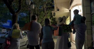 Big family walking in night street after shopping video