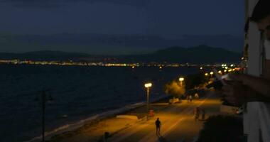 Parents and child with pad on hotel balcony at night video