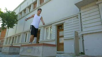 Young athlete performing parkour trick video