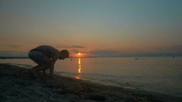 Man doing handstand on the beach at sundown video