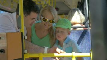 Son and mother using dads smartwatch in the bus video