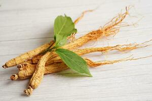 Ginseng roots and green leaf, organic nature healthy food. photo